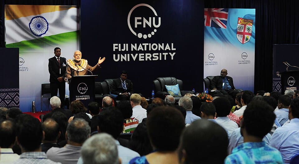 A speaker addressing an audience at a Fiji National University event
